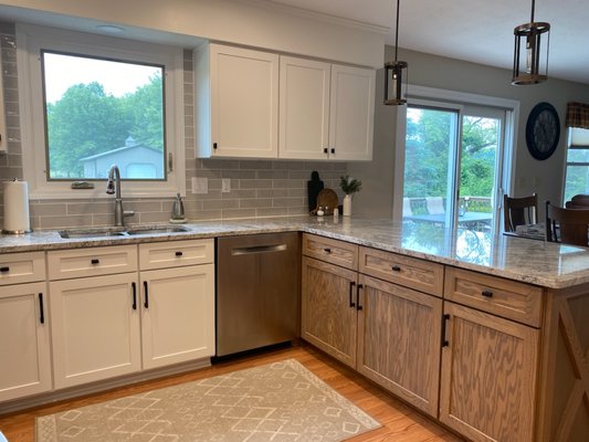 Cabinet Refacing in Galena, Ohio - This kitchen had the common, 1980's honey oak stained cabinetry with a raised panel. The customer was wanting to keep a more traditional approach to their farmhouse style home, so they chose shaker style doors and drawer fronts in a white painted finish and shaker doors and accents on their peninsula also in a shaker style and antique oak stain to turn this kitchen from outdated to a transitional style. Cabinet Refacing in Galena, Ohio - This kitchen had the common, 1980's honey oak stained cabinetry with a raised panel. The customer was wanting to keep a more traditional approach to their farmhouse style home, so they chose shaker style doors and drawer fronts in a white painted finish and shaker doors and accents on their peninsula also in a shaker style and antique oak stain to turn this kitchen from outdated to a transitional style.