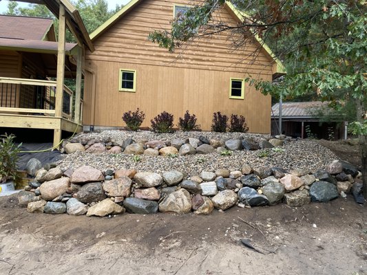 Boulder retaining wall - This project involved building a natural boulder retaining wall to stabilize the slope and improve the overall look of the property. The wall was carefully laid to provide long-term structural support while blending naturally with the surrounding landscape. The finished result adds both durability and visual appeal to the outdoor space.