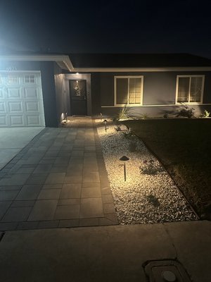 Outdoor pavers - Our amazing customer wanted a change on her front porch, so we came out with this beautiful path of pavers with a nice granite edging, added some color to with plants and white berbaker rock also some outdoor lighting Outdoor pavers - Our amazing customer wanted a change on her front porch, so we came out with this beautiful path of pavers with a nice granite edging, added some color to with plants and white berbaker rock also some outdoor lighting