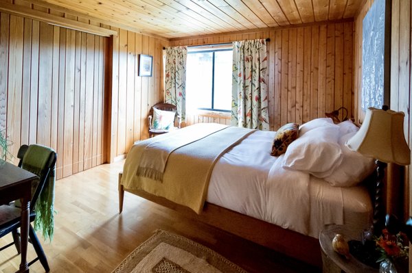 Goldfinch Room - The Goldfinch Room is located on the first floor, with a large window looking out to the meadow and surrounding forest.  Leave your curtains open to watch the sunrise! Features include:
•	The quiet warmth of pine walls and ceiling, and oak floor 
•	Queen size handcrafted maple bed
•	Fine cotton sheets, comforters, and plush towels 
•	Bedside lamps for nighttime reading
•	Private bath featuring a cultured marble sink and walk-in shower
•	Locally made organic soap and shampoo
•	A plush robe for each guest.