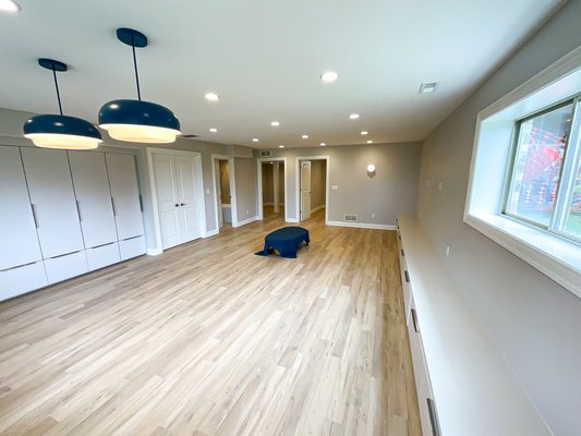 Basement Renovation- Completed Unfinished Space - Our team transformed this basement into a homeowner's dream! The space was completely unfinished with no walls or framing. It is now complete with two finished rooms, a full bathroom, and a spacious living area, this space adds so much value to a home. The beautiful flooring, unique light fixtures, and built in custom cabinetry and storage are a huge plus!