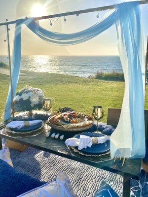 Blue, White, and Gold Birthday Picnic - The client wanted to surprise her boyfriend with a sunset picnic. She picked the location and color scheme after seeing some photos on our Instagram and we put it together for her. She wanted all of the add-ons so it looked extra special. This was a picnic for two. Blue, White, and Gold Birthday Picnic - The client wanted to surprise her boyfriend with a sunset picnic. She picked the location and color scheme after seeing some photos on our Instagram and we put it together for her. She wanted all of the add-ons so it looked extra special. This was a picnic for two.