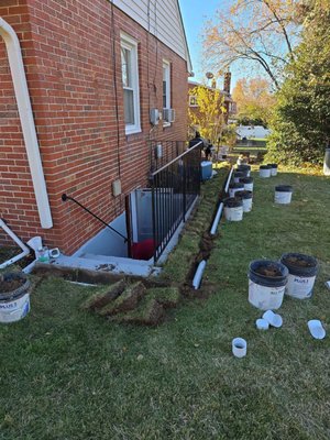 Buried Downspouts - Here are a few photos of a Buried Downspout project. The homeowner wanted a away to send water away from the home's foundation and to avoid the mud and ponding in their yard.  You can see our process through the photos.  What a difference.