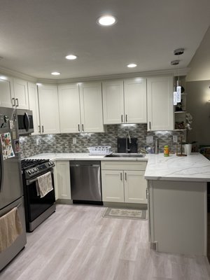 A beautiful kitchen remodel - A Whtie/silver grey cabinet with white countertop A beautiful kitchen remodel - A Whtie/silver grey cabinet with white countertop