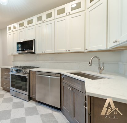 Kitchen Remodel - After completing a bathroom remodel for our client, they contacted us again to take on their kitchen renovation.
We focused on improving both the layout and storage. The sink was relocated to the corner, the refrigerator was moved to create space for a dedicated pantry, and additional cabinetry was added throughout the kitchen.
For the finishes, our client selected Haven Dune off-white wall cabinets paired with Haven Ember stained base and tall cabinets. The design was completed with marble-look porcelain checkerboard flooring, new stone surfaces, lighting, and appliances.
The result is a kitchen that feels completely refreshed while providing better storage, improved workflow, and a layout that makes everyday use easier.
We're proud to have earned our client's trust on their first project and have the opportunity to work with them again. Kitchen Remodel - After completing a bathroom remodel for our client, they contacted us again to take on their kitchen renovation.
We focused on improving both the layout and storage. The sink was relocated to the corner, the refrigerator was moved to create space for a dedicated pantry, and additional cabinetry was added throughout the kitchen.
For the finishes, our client selected Haven Dune off-white wall cabinets paired with Haven Ember stained base and tall cabinets. The design was completed with marble-look porcelain checkerboard flooring, new stone surfaces, lighting, and appliances.
The result is a kitchen that feels completely refreshed while providing better storage, improved workflow, and a layout that makes everyday use easier.
We're proud to have earned our client's trust on their first project and have the opportunity to work with them again.