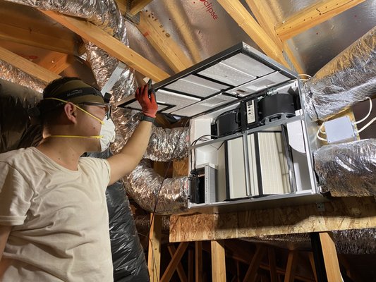 IAQ (Indoor Air Quality) Project - Our team was engaged by a client seeking an Indoor Air Quality (IAQ) solution for his residence. The client had a particular interest in integrating an Energy Recovery Ventilator (ERV) and a High-Efficiency Particulate Air (HEPA) cleaner into his home. In order to ensure precision, he enlisted the expertise of a professional engineer friend in the HVAC industry to assist with the initial schematic design.
**The Challenge**
Although the schematic design was of an exceptional professional caliber, it only served as a broad guide, leaving our team the task of devising a working drawing based on the actual house layout. The residence already had multiple bathroom exhaust fans in place. If operational simultaneously, these could introduce a substantial pressure differential. Moreover, the ERV had a maximum airflow (CFM) capacity of 120, whereas the air cleaner required 150 CFM, prompting us to find an innovative solution to balance these pressure differences. Additionally, the HEPA air cleaner was difficult to procure due to pandemic-related supply chain disruptions, necessitating the formulation of a contingency plan.
**The Solution**
Following a thorough onsite evaluation, we determined the total exhaust airflow and examined the air tightness of the house. Recognizing redundancy in the multiple bathroom fans, we decided to convert several into exhaust vents. This was achieved by removing the internal fan components, including the motor and blades, and rerouting these exhaust points to the ERV. As ERVs continuously exchange energy between the exhausted and incoming air streams, this allowed us to mitigate the airflow imbalance. Despite this, we retained a few strategically placed bathroom fans as a fail-safe should the ERV cease operation.
Owing to the delay in the air cleaner's arrival, we initially installed the ERV, supplementing it with a 4-inch MERV 13 inline filter box placed before the ERV. This was an improvisation over the smaller ERV filter, serving two purposes: enhancing outdoor air cleanliness and protecting the ERV Exchange Capillary Core from dust accumulation.
Upon arrival of the air cleaner, we installed with a 'Tee' configuration between the ERV and the cleaner. An additional external connection, stemming from this 'Tee', was made to an area with acceptable IAQ, aiding in further neutralizing pressure disparities.
**The Result**
The client expressed considerable satisfaction with the project execution, expressing the peace of mind the improved IAQ brought to his home, especially with a newborn in the family. This endeavor not only heightened their living comfort but also contributed positively to their overall health. The client's gratification validated our commitment to client-centric solutions, even amidst unforeseen challenges and logistical constraints. IAQ (Indoor Air Quality) Project - Our team was engaged by a client seeking an Indoor Air Quality (IAQ) solution for his residence. The client had a particular interest in integrating an Energy Recovery Ventilator (ERV) and a High-Efficiency Particulate Air (HEPA) cleaner into his home. In order to ensure precision, he enlisted the expertise of a professional engineer friend in the HVAC industry to assist with the initial schematic design.
**The Challenge**
Although the schematic design was of an exceptional professional caliber, it only served as a broad guide, leaving our team the task of devising a working drawing based on the actual house layout. The residence already had multiple bathroom exhaust fans in place. If operational simultaneously, these could introduce a substantial pressure differential. Moreover, the ERV had a maximum airflow (CFM) capacity of 120, whereas the air cleaner required 150 CFM, prompting us to find an innovative solution to balance these pressure differences. Additionally, the HEPA air cleaner was difficult to procure due to pandemic-related supply chain disruptions, necessitating the formulation of a contingency plan.
**The Solution**
Following a thorough onsite evaluation, we determined the total exhaust airflow and examined the air tightness of the house. Recognizing redundancy in the multiple bathroom fans, we decided to convert several into exhaust vents. This was achieved by removing the internal fan components, including the motor and blades, and rerouting these exhaust points to the ERV. As ERVs continuously exchange energy between the exhausted and incoming air streams, this allowed us to mitigate the airflow imbalance. Despite this, we retained a few strategically placed bathroom fans as a fail-safe should the ERV cease operation.
Owing to the delay in the air cleaner's arrival, we initially installed the ERV, supplementing it with a 4-inch MERV 13 inline filter box placed before the ERV. This was an improvisation over the smaller ERV filter, serving two purposes: enhancing outdoor air cleanliness and protecting the ERV Exchange Capillary Core from dust accumulation.
Upon arrival of the air cleaner, we installed with a 'Tee' configuration between the ERV and the cleaner. An additional external connection, stemming from this 'Tee', was made to an area with acceptable IAQ, aiding in further neutralizing pressure disparities.
**The Result**
The client expressed considerable satisfaction with the project execution, expressing the peace of mind the improved IAQ brought to his home, especially with a newborn in the family. This endeavor not only heightened their living comfort but also contributed positively to their overall health. The client's gratification validated our commitment to client-centric solutions, even amidst unforeseen challenges and logistical constraints.