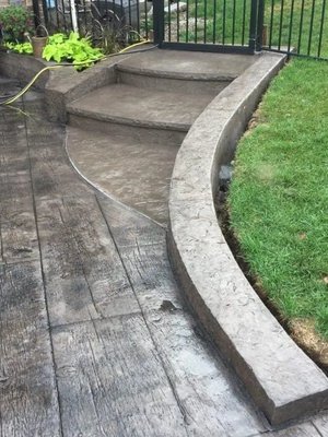 Stamped Concrete - Stamped concrete is a great way to turn boring flat concrete into a beautifully textured surface. It’s extremely popular for patios, pool decks, entryways, and a variety of other surfaces around the home.
Whether you’re looking for an elegant design or something that mimics wood planks, we provide multiple stamped patterns to choose from. Stamped Concrete - Stamped concrete is a great way to turn boring flat concrete into a beautifully textured surface. It’s extremely popular for patios, pool decks, entryways, and a variety of other surfaces around the home.
Whether you’re looking for an elegant design or something that mimics wood planks, we provide multiple stamped patterns to choose from.