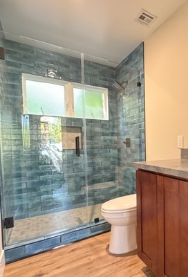Blue Pool Bathroom - Aqua Bella pool tiles LVP flooring, Espresso Cabinets and Frameless Tempered Glass