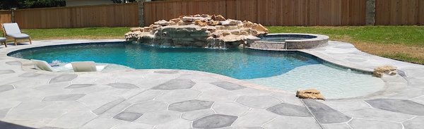 The Waterfall Pool - This luxury-style pool is larger than it appears—and packed with premium features. Our free-form Waterfall Pool stretches over 40 feet in length and showcases a stunning 23 foot-wide waterfall standing more than four and a half feet tall. It includes a classic round Spa with a spillover edge, an oversized Tanning Ledge, and an expansive walk-in Beach Entry—perfect for anyone who loves both beauty and functionality.
The two-tone Plaster finish highlights the Tanning Ledge and Beach Entry, making them visually stand out, while the patterned concrete Decking adds the perfect finishing touch to this luxurious backyard centerpiece. It’s a space your friends and family will enjoy for years to come.
Best of all, the Waterfall Pool can be customized to fit your backyard.
Call Rio Mar Pools today to schedule your consultation. The Waterfall Pool - This luxury-style pool is larger than it appears—and packed with premium features. Our free-form Waterfall Pool stretches over 40 feet in length and showcases a stunning 23 foot-wide waterfall standing more than four and a half feet tall. It includes a classic round Spa with a spillover edge, an oversized Tanning Ledge, and an expansive walk-in Beach Entry—perfect for anyone who loves both beauty and functionality.
The two-tone Plaster finish highlights the Tanning Ledge and Beach Entry, making them visually stand out, while the patterned concrete Decking adds the perfect finishing touch to this luxurious backyard centerpiece. It’s a space your friends and family will enjoy for years to come.
Best of all, the Waterfall Pool can be customized to fit your backyard.
Call Rio Mar Pools today to schedule your consultation.