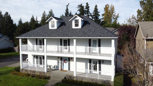 Everett Roof, Siding, Deck, Doors, Railing, & Gutters Makeover - This beautiful colonial style home received a FULL makeover with all new James Hardie ColorPlus Siding in Arctic White, Northgate roof in Moire Black, Fiberglass doors by Codel Entry Systems, DecTec Vinyl Decking, white Peak Aluminum Railing, and K-Style Seamless Gutters.