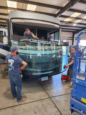 Motorcoach and Bus Glass Replacement - Various types of RVs, including motor homes, suffer a great deal of wear and tear from long drives. The glass windows and windshields of these vehicles are frequently damaged by debris that gets kicked up on the highway. Bad weather can also damage them, with debris from thunderstorms or hailstones. The sun can also damage the interiors.

While it’s always best to repair a chip or crack, sometimes it’s just not possible. When the windshield or windows of your motor home need replacement, trust a shop that has a track record of being able to get those large windows back in place. That includes jacking the coach body back into place, after a jack malfunction, or a road complication that caused an unforeseen crack to appear from nowhere.