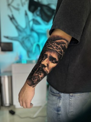 Julio Calderon - Hes been doing this over 20+ years. A Vet, a heavy hitter in this industry! He specializes in black and grey realism, but that does not limit his skill to just black and grey. He dabs into color occasionally. He does amazing portraits, including animals for all you animal lovers! He does aztec style, movie scenes and enjoys doing scenery tattoos as well. He ll bring your idea to life! You are a definite asset to our team! Julio Calderon - Hes been doing this over 20+ years. A Vet, a heavy hitter in this industry! He specializes in black and grey realism, but that does not limit his skill to just black and grey. He dabs into color occasionally. He does amazing portraits, including animals for all you animal lovers! He does aztec style, movie scenes and enjoys doing scenery tattoos as well. He ll bring your idea to life! You are a definite asset to our team!