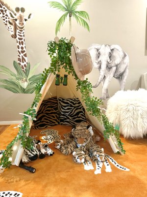 Safari Playroom - This room was designed for two little girls who's grandmother wanted a safe and cozy place for them to dream and play. We designed a custom sofa and custom trundle bed for them both to sleep and created a whimsical safari themed space with custom art, beautiful animal wall decals, custom wool rug and plenty of fun details to keep the kiddos inspired and excited.