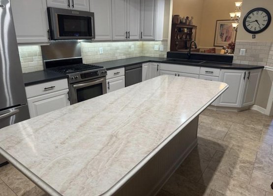 Taj Mahal Quartz Island With Midnight Majesty Quartz around the perimeter - Modern kitchen featuring Midnight Majesty quartz with a concrete finish on the perimeter and Taj Mahal quartz on the island with a custom ogee edge detail. A perfect blend of bold design and timeless elegance. Taj Mahal Quartz Island With Midnight Majesty Quartz around the perimeter - Modern kitchen featuring Midnight Majesty quartz with a concrete finish on the perimeter and Taj Mahal quartz on the island with a custom ogee edge detail. A perfect blend of bold design and timeless elegance.