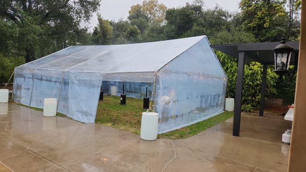 Clear Tent Event - This 30x40 Tent with Bistro lighting was installed in the middle of the rain. These tents are fire retardant, they keep the heat really well and they allow you to show off the view outside as well.