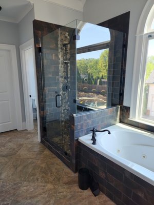 MASTER BATHROOM REMODEL - Our team transformed this cramped master bathroom by replacing the vanities and bulky built in tub/shower. The stand-alone glass shower creates a seemingly larger, more defined space.