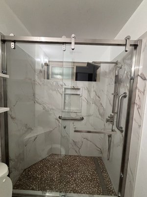 Walk in shower conversion - Our client wanted to to convert her bath shower into a more accessible walk in shower, keeping in mind she wanted to still be able to relax which lead us to adding a seat inside along side some grab bars. Walk in shower conversion - Our client wanted to to convert her bath shower into a more accessible walk in shower, keeping in mind she wanted to still be able to relax which lead us to adding a seat inside along side some grab bars.