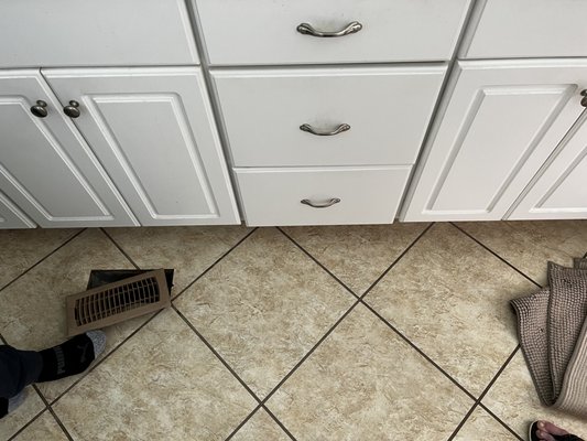 Vent relocation - Customer was tired of cold air blowing on his feet - we relocated the vent and patched the tile Vent relocation - Customer was tired of cold air blowing on his feet - we relocated the vent and patched the tile