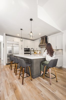 Kitchen Remodel - Bexley - This complete kitchen overhaul features a reimagined layout with new porcelain floors, contrasting Homecrest cabinets, Blanco Orion quartz counters, and a stylish hex backsplash. Finished with premium JennAir appliances, the transformation blends modern design, functionality, and lasting value.