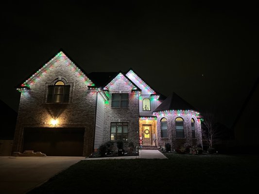 Front of House Color Changing Roofline Lighting - Another happy homeowner in Clarksville! This customer wanted a clean, premium permanent lighting solution that could do more than just Christmas lights — and the final result turned out beautifully.
Their new permanent roofline lighting system gives them the flexibility to celebrate holidays year-round with customizable colors and animations, while also providing elegant architectural accent lighting and practical security lighting every night of the year. From crisp warm white lighting for everyday curb appeal to vibrant holiday scenes for Christmas, the entire system is controlled directly from an app on their phone.
The customer was thrilled with how seamlessly the lighting blended into the roofline during the daytime and how dramatically it transformed the home at night. Projects like this are exactly why we love designing permanent lighting systems — beautiful, functional, and built to enjoy every season of the year. Front of House Color Changing Roofline Lighting - Another happy homeowner in Clarksville! This customer wanted a clean, premium permanent lighting solution that could do more than just Christmas lights — and the final result turned out beautifully.
Their new permanent roofline lighting system gives them the flexibility to celebrate holidays year-round with customizable colors and animations, while also providing elegant architectural accent lighting and practical security lighting every night of the year. From crisp warm white lighting for everyday curb appeal to vibrant holiday scenes for Christmas, the entire system is controlled directly from an app on their phone.
The customer was thrilled with how seamlessly the lighting blended into the roofline during the daytime and how dramatically it transformed the home at night. Projects like this are exactly why we love designing permanent lighting systems — beautiful, functional, and built to enjoy every season of the year.