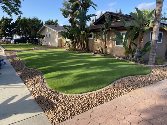 Anaheim  front yard remodel with artificial turf. - This project was in Anaheim, CA. We installed Artificial Grass and river rock with a paver edge border.