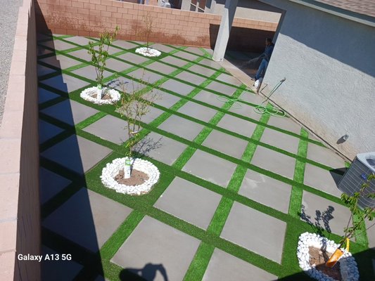 Concrete squares with synthetic turf - Customer wanted squares in a 45 degree with grass in between also white rock circles around trees Concrete squares with synthetic turf - Customer wanted squares in a 45 degree with grass in between also white rock circles around trees