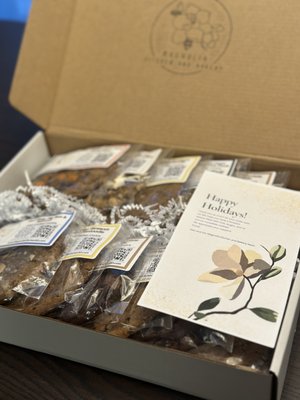Corporate Gifts - Magnolia Kitchen & Bakery makes award-winning cookie gift boxes and cookie assortments, baked by a Michelin-trained chef and shipped nationwide. Skip the branded pen and the generic gift basket: send the best cookies in San Diego as client gifts, employee gifts, holiday gifts and thank-you gifts. Whether you want a corporate cookie box, a holiday cookie assortment or a bulk gift order, we make it simple.
CORPORATE GIFTS THAT STAND OUT
Our cookie box is a favorite for corporate gifting in San Diego's tech, biotech, energy, finance and professional services teams. Use it for client gifts, vendor and partner thank-yous, employee appreciation gifts, new-hire welcome gifts, milestone and anniversary gifts, executive gifts, closing gifts and referral gifts. Every gift box is wrapped, and every cookie is individually wrapped and labeled with ingredients and allergen information.
COOKIE BOXES AND COOKIE ASSORTMENTS
Choose the cookie gift box that fits your budget and your list:
- 6-pack cookie assortment: one of each signature flavor, $36
- 5-pack cookie box: your favorite picks or our curated assortment, $30
- 4-pack gift box: a perfect individual thank-you gift, $24
Shipping is $10 per box. Add granola or minis for $22 per bag, Grandma BB's Sour Cream Coffee Cake for $42, or extra cookies for $8 each. We also build larger corporate gift tiers for executives and top clients, with custom labels and ribbon to match your brand, your logo colors and your message.
HOLIDAY COOKIES AND HOLIDAY GIFT BOXES
Holiday gifts are our busiest season, and holiday cookies are the corporate holiday gift everyone loves. Send a holiday cookie box to clients, employees and partners across the country, with seasonal cookie specials available throughout the year. Order early to reserve your delivery date, especially for bulk orders and nationwide shipping in November and December.
SIGNATURE COOKIE FLAVORS IN EVERY GIFT BOX
- Salted Brown Butter Chocolate Chip, our best seller
- Espresso, Toffee, Chocolate & Sea Salt
- S'mores with Fire Roasted Marshmallow
- Orange Blossom Snickerdoodle
- Earl Grey, Fig Jam & Almond
- Peanut Butter, Brown Butter & Butterfinger
- Tahini Oat Chocolate Chunk (gluten free and vegan, available on request)
Our gourmet cookies are chef-crafted, not mass-produced. We balance salt, acidity, bitterness and texture instead of chasing pure sweetness. Local chefs, including Brian Malarkey of Top Chef and Travis Swikard, have called Magnolia's cookies among the best in San Diego, and at the 2026 San Diego County Fair our Salted Brown Butter Chocolate Chip and Espresso, Toffee, Chocolate & Sea Salt cookies both earned "Too Good to Last."
CORPORATE GIFT IDEAS BY OCCASION
- Client thank-you gifts: a 6-pack cookie assortment with a personal note
- Corporate holiday gifts: a holiday cookie box for your whole client list
- Employee appreciation gifts: a box for every team member, delivered to the office
- New-hire welcome gifts: a 4-pack waiting on day one
- Closing, referral and business gifts that get remembered
WHY COMPANIES CHOOSE MAGNOLIA FOR CORPORATE GIFTING
- A gourmet gift people eat and talk about, not another logo item
- Award-winning, chef-crafted cookies
- Gluten-free and vegan option with clear allergen labels
- Bulk and custom corporate gift orders with clear pricing
- Local delivery and nationwide shipping, handled for you
CUSTOM FLAVORS AND PERSONALIZED GIFTS
Want a personalized corporate gift? For repeat clients we have created more than a dozen custom flavors, such as black sesame yuzu, corn chili lime and jasmine passion fruit guava. Ask about custom flavors, custom labels and branded ribbon for your executive team, event or brand.
EASY BULK ORDERING AND RECURRING GIFTS
Gifting a long list? Send us your recipient names and addresses, your message and your delivery date, and we'll handle the packing and shipping. Planning quarterly client gifts, birthday gifts or work anniversary gifts? We can set up a recurring corporate gifting program.
CORPORATE CATERING AND DESSERT CATERING TOO
Need dessert for the office as well? We provide corporate catering, dessert catering and cookie catering for corporate lunches, client events and team celebrations, so you can thank clients and celebrate your team in a single order.
HOW TO ORDER
Message us with your quantity, budget, delivery date and any branding or flavor requests for a custom quote, and order early for the holidays. Local delivery is available throughout San Diego, including La Jolla, Del Mar, Carlsbad, Encinitas, Rancho Bernardo, Poway and downtown, and we ship nationwide so out-of-town clients get the same gift. Corporate Gifts - Magnolia Kitchen & Bakery makes award-winning cookie gift boxes and cookie assortments, baked by a Michelin-trained chef and shipped nationwide. Skip the branded pen and the generic gift basket: send the best cookies in San Diego as client gifts, employee gifts, holiday gifts and thank-you gifts. Whether you want a corporate cookie box, a holiday cookie assortment or a bulk gift order, we make it simple.
CORPORATE GIFTS THAT STAND OUT
Our cookie box is a favorite for corporate gifting in San Diego's tech, biotech, energy, finance and professional services teams. Use it for client gifts, vendor and partner thank-yous, employee appreciation gifts, new-hire welcome gifts, milestone and anniversary gifts, executive gifts, closing gifts and referral gifts. Every gift box is wrapped, and every cookie is individually wrapped and labeled with ingredients and allergen information.
COOKIE BOXES AND COOKIE ASSORTMENTS
Choose the cookie gift box that fits your budget and your list:
- 6-pack cookie assortment: one of each signature flavor, $36
- 5-pack cookie box: your favorite picks or our curated assortment, $30
- 4-pack gift box: a perfect individual thank-you gift, $24
Shipping is $10 per box. Add granola or minis for $22 per bag, Grandma BB's Sour Cream Coffee Cake for $42, or extra cookies for $8 each. We also build larger corporate gift tiers for executives and top clients, with custom labels and ribbon to match your brand, your logo colors and your message.
HOLIDAY COOKIES AND HOLIDAY GIFT BOXES
Holiday gifts are our busiest season, and holiday cookies are the corporate holiday gift everyone loves. Send a holiday cookie box to clients, employees and partners across the country, with seasonal cookie specials available throughout the year. Order early to reserve your delivery date, especially for bulk orders and nationwide shipping in November and December.
SIGNATURE COOKIE FLAVORS IN EVERY GIFT BOX
- Salted Brown Butter Chocolate Chip, our best seller
- Espresso, Toffee, Chocolate & Sea Salt
- S'mores with Fire Roasted Marshmallow
- Orange Blossom Snickerdoodle
- Earl Grey, Fig Jam & Almond
- Peanut Butter, Brown Butter & Butterfinger
- Tahini Oat Chocolate Chunk (gluten free and vegan, available on request)
Our gourmet cookies are chef-crafted, not mass-produced. We balance salt, acidity, bitterness and texture instead of chasing pure sweetness. Local chefs, including Brian Malarkey of Top Chef and Travis Swikard, have called Magnolia's cookies among the best in San Diego, and at the 2026 San Diego County Fair our Salted Brown Butter Chocolate Chip and Espresso, Toffee, Chocolate & Sea Salt cookies both earned "Too Good to Last."
CORPORATE GIFT IDEAS BY OCCASION
- Client thank-you gifts: a 6-pack cookie assortment with a personal note
- Corporate holiday gifts: a holiday cookie box for your whole client list
- Employee appreciation gifts: a box for every team member, delivered to the office
- New-hire welcome gifts: a 4-pack waiting on day one
- Closing, referral and business gifts that get remembered
WHY COMPANIES CHOOSE MAGNOLIA FOR CORPORATE GIFTING
- A gourmet gift people eat and talk about, not another logo item
- Award-winning, chef-crafted cookies
- Gluten-free and vegan option with clear allergen labels
- Bulk and custom corporate gift orders with clear pricing
- Local delivery and nationwide shipping, handled for you
CUSTOM FLAVORS AND PERSONALIZED GIFTS
Want a personalized corporate gift? For repeat clients we have created more than a dozen custom flavors, such as black sesame yuzu, corn chili lime and jasmine passion fruit guava. Ask about custom flavors, custom labels and branded ribbon for your executive team, event or brand.
EASY BULK ORDERING AND RECURRING GIFTS
Gifting a long list? Send us your recipient names and addresses, your message and your delivery date, and we'll handle the packing and shipping. Planning quarterly client gifts, birthday gifts or work anniversary gifts? We can set up a recurring corporate gifting program.
CORPORATE CATERING AND DESSERT CATERING TOO
Need dessert for the office as well? We provide corporate catering, dessert catering and cookie catering for corporate lunches, client events and team celebrations, so you can thank clients and celebrate your team in a single order.
HOW TO ORDER
Message us with your quantity, budget, delivery date and any branding or flavor requests for a custom quote, and order early for the holidays. Local delivery is available throughout San Diego, including La Jolla, Del Mar, Carlsbad, Encinitas, Rancho Bernardo, Poway and downtown, and we ship nationwide so out-of-town clients get the same gift.