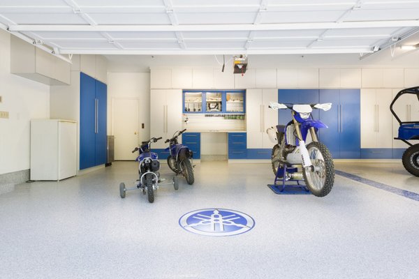 Custom Garage Remodel - Take a look at this customer's dream garage complete with color matching cabinets doors, work bench, custom flooring with logos, hanging wall unit and more!