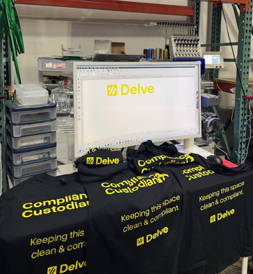 Custom Rush Shirts for Delve Technologies Inc. Event - We recently had the pleasure of working with Delve Technologies Inc. for their “Avoiding Identity & Compliance Scope Creep – Happy Hour & Fireside Chat” event.

Zee from Delve reached out on short notice asking if we could handle a rush shirt order. We gladly accepted and worked closely together to choose the right shirt colors and sizes. Originally, the plan was for two shirts, but due to limited color availability, we suggested reversing the shirt and print colors — and the result turned out even better than expected!

After seeing the first design, the team loved it so much that their friends asked for three more shirts, all on an even tighter deadline. We made it happen and delivered everything just in time at the event location before it started.

The final shirts looked amazing, and we’re excited to hear how the team reacted!
We truly enjoyed collaborating with a local YC-backed AI company like Delve — especially after seeing their recent Series A announcement ($32M at a $300M valuation).

Always a pleasure supporting innovative local teams like Delve Technologies!
