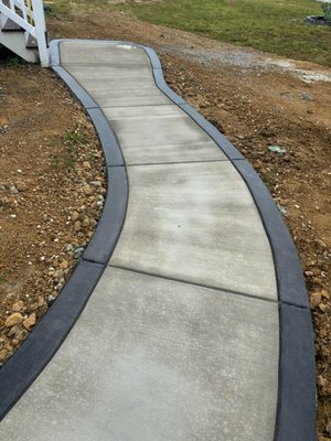 Queen Emily Walkway Project - Custom continuous concrete landscape edging installed around a front flower bed in Richmond, VA Queen Emily Walkway Project - Custom continuous concrete landscape edging installed around a front flower bed in Richmond, VA