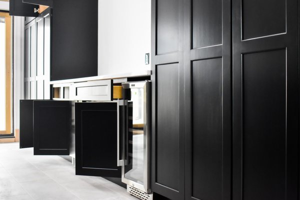 Cabinet Painting - Philadelphia, PA - In the heart of Fishtown, Philadelphia, Dambrak Painting embarked on a remarkable project, completely transforming a chef's kitchen into a culinary oasis. With over 60 cabinet doors and two flights of cabinets, the challenge was met with precision and artistry. The bold choice of a rich black color for the cabinets added an air of sophistication and drama, while the careful execution allowed ample natural light to play a vital role in enhancing the overall aesthetic. The crowning touch came in the form of luxurious golden knobs and appliances, creating a seamless fusion of opulence and functionality. Dambrak Painting's unwavering commitment to realizing the customer's vision resulted in a chef's kitchen that not only exceeded expectations but also stood as a testament to the marriage of design and craftsmanship, making it the heart of culinary creativity in Fishtown. Cabinet Painting - Philadelphia, PA - In the heart of Fishtown, Philadelphia, Dambrak Painting embarked on a remarkable project, completely transforming a chef's kitchen into a culinary oasis. With over 60 cabinet doors and two flights of cabinets, the challenge was met with precision and artistry. The bold choice of a rich black color for the cabinets added an air of sophistication and drama, while the careful execution allowed ample natural light to play a vital role in enhancing the overall aesthetic. The crowning touch came in the form of luxurious golden knobs and appliances, creating a seamless fusion of opulence and functionality. Dambrak Painting's unwavering commitment to realizing the customer's vision resulted in a chef's kitchen that not only exceeded expectations but also stood as a testament to the marriage of design and craftsmanship, making it the heart of culinary creativity in Fishtown.