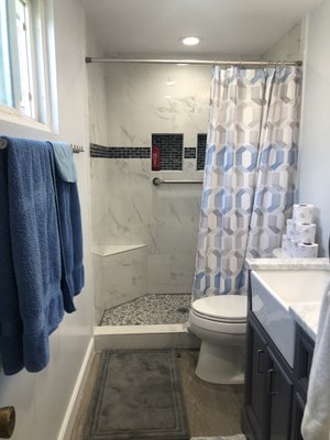 Bathroom Remodel - This bathroom needed a quick fresh update. We removed the pre fab acryilic srroundings and installed new tiles,new vanity, and painted the entire bathroom.