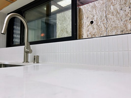 Modern Backsplash - This client chose a small formatted vertical tile layout to compliment the recently installed granite counter tops Modern Backsplash - This client chose a small formatted vertical tile layout to compliment the recently installed granite counter tops