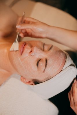 Facials and Skin Therapy - If there’s one outcome that unites nearly every guest who walks through our doors, it’s the desire to GLOW. Hydration is the engine behind that glassy look. Dry, depleted skin looks tired and emphasizes every fine line; well-hydrated skin looks plump, smooth, and light-reflecting — the very definition of the glassy skin look. Our hydrating facials, supported by the customizable hydration focus are engineered to flood the skin with moisture and lock it in.
What makes our approach to hydrating facials different is the combination of immediate payoff and long-term strategy. You leave your appointment with visibly dewier skin, but your skin therapist also sends you off with a plan — the products, the cadence, and the Elevations that keeps moisture levels high between visits. Glassy skin, after all, isn’t a single appointment; it’s a habit. With Dermalogica serums and treatments like IonActive Serum infusions, that habit becomes far easier to sustain, and your glow becomes your everyday baseline rather than a once-in-a-while treat.