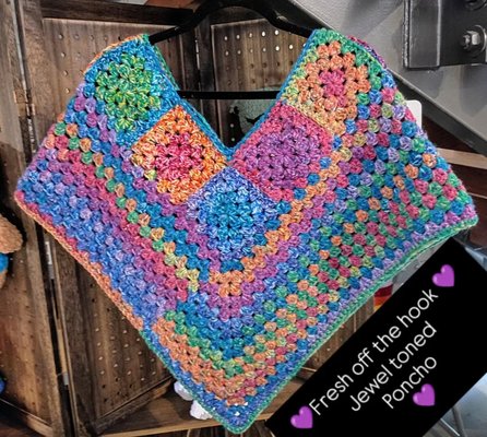 Knitted Fashion - Stay warm and stylish with our handmade crochet sweaters, ponchos and other fashion! Each item is crafted with love using soft, multi-colored yarn that creates a beautiful, eye-catching gradient. Perfect for layering in any season, these ponchos add a touch of artisanal charm to any outfit.

Want to make your own? Join our crochet classes and learn step-by-step how to crochet stunning ponchos like this one! Our friendly instructors will guide you through each stitch, from beginner basics to finishing techniques, so you can create a one-of-a-kind wearable work of art.
