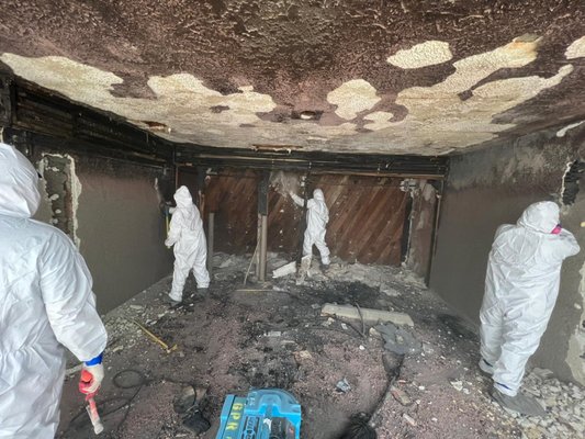 Emergency Fire & Smoke Damage Mitigation Service - Fire started in this apt. building carport, burning the garage and adjacent laundry/water heater room, the front upper and lower units suffered smoke and soot damage as a result.