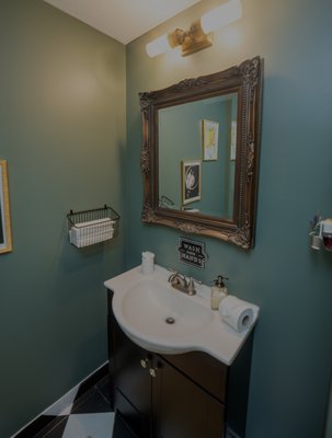 Powder Room Renovation - This powder room was taken from old and dingy to a custom speak easy design in a matter of days. Featuring hand-painted flooring, custom artwork, and vintage decor, this bathroom is sure to impress. Powder Room Renovation - This powder room was taken from old and dingy to a custom speak easy design in a matter of days. Featuring hand-painted flooring, custom artwork, and vintage decor, this bathroom is sure to impress.