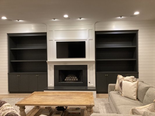 Black and White Cabinetry Combination in Newport Beach CA - Finely Painted Black Built-In Cabinetry, Surrounded by White Shiplap and Mantle, in Orange County CA. Black and White Cabinetry Combination in Newport Beach CA - Finely Painted Black Built-In Cabinetry, Surrounded by White Shiplap and Mantle, in Orange County CA.