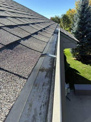 Window and gutter cleaning job - See the difference a professional cleaning makes! We removed built-up dirt, grime, and debris from the windows and gutters, leaving the windows looking clean and clear and the gutters free of buildup. Regular window and gutter cleaning helps keep your home looking its best and your gutters flowing properly.