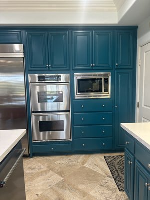 Kichen cabinet painting - Full repaint of existing raised-panel cabinets and island. No demo, no new boxes—just proper prep and a factory-smooth finish.

What we did:
Removed & labeled all doors/drawers; hardware bagged by location
Degreased (kitchen-grade), sanded, repairs filled, seams caulked
Applied an adhesion/bonding primer for long-term hold
Sprayed a special 2k cabinet enamel 
Boxes, doors, drawers are all sprayed for smoothest finish, we inspect after each coat for the perfect finish.
Reinstalled/adjusted doors & drawers; hardware cleaned and reinstalled

Why it works:
Professional prep = no peeling, no sticky doors
Sprayed 2k finish = factory look without replacing cabinets, chemical resistant with the highest durability
Faster, cleaner, and far more budget-friendly than new cabinetry

Timeline: Typical kitchens like this take 4–5 working days (on-site).