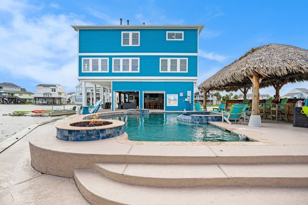 New Rental in Jamaica Beach - Whether you’re looking for a relaxing getaway or an adventure-filled vacation, Livin’ the Dream by Beachbox has it all!
Imagine waking up each morning to stunning views of the bay and enjoying your morning coffee on the spacious deck in this 7 Bedroom/5 Bath waterfront home. Spend your days lounging by the pool under the warm sun, fishing off the dock, or taking the kayaks out for a scenic tour of the bay. In the evenings, gather around the fire pit and roast marshmallows while watching the sunset over the water.
Inside, you’ll find the home beautifully decorated with a coastal-inspired theme and all the amenities you could need for a comfortable stay. The kitchen is fully equipped with modern appliances and the open concept layout makes it easy to entertain and spend time with loved ones.
Located just a short drive from Galveston’s famous attractions, including the Historic Pleasure Pier and Moody Gardens, Livin’ the Dream by Beachbox is the perfect home base for exploring the island. And after a day of fun, you can come back to your own private oasis and unwind in the private pool and hot tub. New Rental in Jamaica Beach - Whether you’re looking for a relaxing getaway or an adventure-filled vacation, Livin’ the Dream by Beachbox has it all!
Imagine waking up each morning to stunning views of the bay and enjoying your morning coffee on the spacious deck in this 7 Bedroom/5 Bath waterfront home. Spend your days lounging by the pool under the warm sun, fishing off the dock, or taking the kayaks out for a scenic tour of the bay. In the evenings, gather around the fire pit and roast marshmallows while watching the sunset over the water.
Inside, you’ll find the home beautifully decorated with a coastal-inspired theme and all the amenities you could need for a comfortable stay. The kitchen is fully equipped with modern appliances and the open concept layout makes it easy to entertain and spend time with loved ones.
Located just a short drive from Galveston’s famous attractions, including the Historic Pleasure Pier and Moody Gardens, Livin’ the Dream by Beachbox is the perfect home base for exploring the island. And after a day of fun, you can come back to your own private oasis and unwind in the private pool and hot tub.