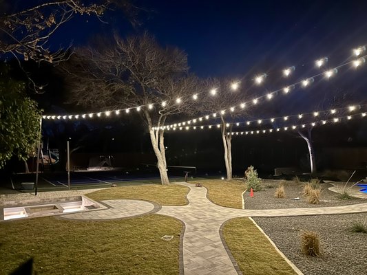 Residential LED Outdoor Lighting & Sport Court Installation - This custom LED outdoor lighting project transformed the backyard into a fully functional and inviting nighttime space. Our team installed energy-efficient sport court lighting for safe, even illumination, along with recessed LED fire pit and step lighting to enhance both safety and ambiance. We also added commercial-grade string lighting to create a warm, elegant atmosphere throughout the outdoor living areas.
All lighting was professionally designed and installed by a licensed residential electrician, using high-quality, low-voltage and LED fixtures for long-lasting performance and energy efficiency. The result is a modern, well-lit backyard ideal for recreation, relaxation, and entertaining.
We specialize in custom residential outdoor lighting, landscape lighting, sport court lighting, and high-end backyard electrical installations. Residential LED Outdoor Lighting & Sport Court Installation - This custom LED outdoor lighting project transformed the backyard into a fully functional and inviting nighttime space. Our team installed energy-efficient sport court lighting for safe, even illumination, along with recessed LED fire pit and step lighting to enhance both safety and ambiance. We also added commercial-grade string lighting to create a warm, elegant atmosphere throughout the outdoor living areas.
All lighting was professionally designed and installed by a licensed residential electrician, using high-quality, low-voltage and LED fixtures for long-lasting performance and energy efficiency. The result is a modern, well-lit backyard ideal for recreation, relaxation, and entertaining.
We specialize in custom residential outdoor lighting, landscape lighting, sport court lighting, and high-end backyard electrical installations.
