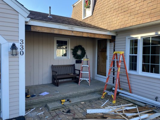 Breezeway Remodel 2024 - This customer wanted to turn this outdoor space into a usable and functional mudroom/breezeway. We installed two French doors with glass side panels, Azek exterior trim, gutters and a new concrete step. On the interior, pine bead board was installed on the walls and ceiling along with pine baseboards. Contact us if you're interested in discussing your next home improvement project!