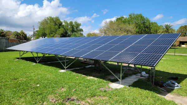 11.52kW Ground Mount Residential System with Battery Backup, Davie, Florida - This customer didn't want to mount the system on his roof, so we designed a substantial ground mounted system in his large yard. He wanted battery backup, so we provided a Generac turnkey solution. Their batteries backup their critical loads during utility outages and help offset their electricity into the evening hours.