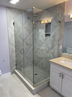 Master bathroom remodel. - The shower in this master bathroom had failed and was leaking into the downstairs. We came in and demoed, prepped and waterproofed the shower. reinstalled new 24 x 24 patterned tile with a double soap niche and frameless glass door. The homeowner also decided to demo the floor And add a freestanding tub with tub surround.
