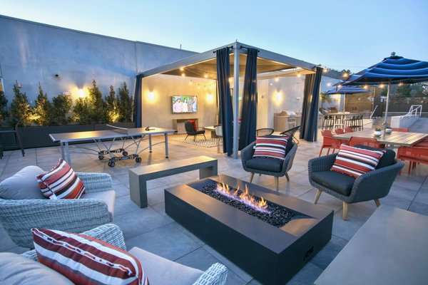 Empire At Norton Condo - Rooftop Pool Deck - Tile Tech Pedestals and 24×24 Porcelain Pavers in Gray Stone & Wood Plank series in addition to IPE Wood Deck Tiles crown the rooftop with luxury, transforming it into usable community space, perfect for entertaining. Shady pergolas and furniture all add to the elegance of the rooftop deck. Additionally, the Tile Tech Paver products used to construct the rooftop deck added to the building’s LEED Certification.