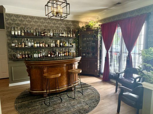 A Bold Twist on a Classic Space - I transformed an outdated formal dining room into a sleek, modern speakeasy—complete with hand-painted wallpaper, custom window treatments, built-in shelving, and a handcrafted wine rack. I installed a statement chandelier and dimmer switch to set the mood and finished it all with bold, modern touches for a space that’s equal parts cozy and elevated. A Bold Twist on a Classic Space - I transformed an outdated formal dining room into a sleek, modern speakeasy—complete with hand-painted wallpaper, custom window treatments, built-in shelving, and a handcrafted wine rack. I installed a statement chandelier and dimmer switch to set the mood and finished it all with bold, modern touches for a space that’s equal parts cozy and elevated.