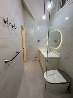 Master Bathroom Remodel | Los Gatos - This bathroom was taken down to the studs and rebuilt from the ground up. We installed floor-to-ceiling porcelain tile, a custom shower niche, frameless glass, a modern floating-style vanity with an LED mirror, new recessed lighting, and a complete waterproof shower system. The finished space feels brighter, larger, and brings a clean, timeless look that will last for years. Master Bathroom Remodel | Los Gatos - This bathroom was taken down to the studs and rebuilt from the ground up. We installed floor-to-ceiling porcelain tile, a custom shower niche, frameless glass, a modern floating-style vanity with an LED mirror, new recessed lighting, and a complete waterproof shower system. The finished space feels brighter, larger, and brings a clean, timeless look that will last for years.