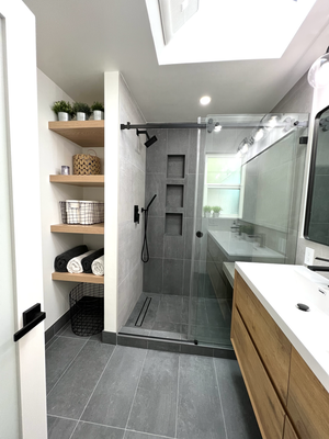 Los Altos Master Bathroom Remodel - In this project, we transformed a standard master bathroom into a stunning and functional space that exudes modern elegance.
Our renovation involved several key enhancements, starting with expanding the shower area to provide a more luxurious experience. We added a spacious shower bench, offering a comfortable seating option and a touch of spa-like indulgence. The shower upgrade was complemented by the conversion of the toilet to a wall-hung design, maximizing floor space and creating a sleek, streamlined look.
To further elevate the bathroom's aesthetic appeal, we installed a beautiful double vanity, providing ample storage and countertop space for everyday essentials. The custom-made wood shelves were carefully crafted, adding warmth and charm to the room while serving as both functional and decorative elements.
Natural light is a key feature in any well-designed bathroom, and we achieved this by introducing a skylight that floods the space with sunshine, creating a bright and airy atmosphere. The choice of colors played a significant role in the remodel, with a harmonious blend of grey tones and wood accents. This color palette strikes the perfect balance between modern sophistication and natural warmth, resulting in a timeless and inviting ambiance.
Our bathroom remodel showcases the perfect fusion of functionality, style, and comfort. We take pride in our attention to detail, ensuring that every element is carefully considered and expertly executed. Take a look at the images below to appreciate the transformation and get inspired for your own project. Los Altos Master Bathroom Remodel - In this project, we transformed a standard master bathroom into a stunning and functional space that exudes modern elegance.
Our renovation involved several key enhancements, starting with expanding the shower area to provide a more luxurious experience. We added a spacious shower bench, offering a comfortable seating option and a touch of spa-like indulgence. The shower upgrade was complemented by the conversion of the toilet to a wall-hung design, maximizing floor space and creating a sleek, streamlined look.
To further elevate the bathroom's aesthetic appeal, we installed a beautiful double vanity, providing ample storage and countertop space for everyday essentials. The custom-made wood shelves were carefully crafted, adding warmth and charm to the room while serving as both functional and decorative elements.
Natural light is a key feature in any well-designed bathroom, and we achieved this by introducing a skylight that floods the space with sunshine, creating a bright and airy atmosphere. The choice of colors played a significant role in the remodel, with a harmonious blend of grey tones and wood accents. This color palette strikes the perfect balance between modern sophistication and natural warmth, resulting in a timeless and inviting ambiance.
Our bathroom remodel showcases the perfect fusion of functionality, style, and comfort. We take pride in our attention to detail, ensuring that every element is carefully considered and expertly executed. Take a look at the images below to appreciate the transformation and get inspired for your own project.