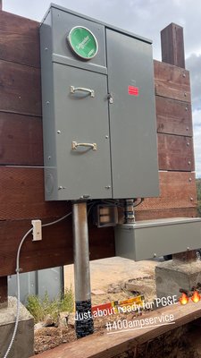 400A Premium Residential Service - This installation features a Schneider Electric (Square D) 400 Amp All-In-One Service Entrance Device, specifically engineered to manage the high-demand loads of a modern custom estate.
• High-Capacity Distribution: Designed to seamlessly power a large-scale custom home and a high-performance infinity pool system.
• Future-Proof Design: The equipment is strategically offset on a custom timber backboard, specifically leaving dedicated "real estate" for the integration of Solar PV inverters, ESS (Battery Backup), and an Automatic Transfer Switch (ATS) for a standby generator.
• Infrastructure: Features a heavy-duty rigid metal conduit (RMC) mast with protective corrosion wrapping at the grade level, ensuring long-term structural integrity in varied soil conditions.
• Safety & Compliance: Includes a dedicated emergency disconnect and integrated sub-feed capabilities to allow for easy expansion without requiring a service upgrade later. 400A Premium Residential Service - This installation features a Schneider Electric (Square D) 400 Amp All-In-One Service Entrance Device, specifically engineered to manage the high-demand loads of a modern custom estate.
• High-Capacity Distribution: Designed to seamlessly power a large-scale custom home and a high-performance infinity pool system.
• Future-Proof Design: The equipment is strategically offset on a custom timber backboard, specifically leaving dedicated "real estate" for the integration of Solar PV inverters, ESS (Battery Backup), and an Automatic Transfer Switch (ATS) for a standby generator.
• Infrastructure: Features a heavy-duty rigid metal conduit (RMC) mast with protective corrosion wrapping at the grade level, ensuring long-term structural integrity in varied soil conditions.
• Safety & Compliance: Includes a dedicated emergency disconnect and integrated sub-feed capabilities to allow for easy expansion without requiring a service upgrade later.